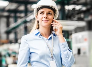 portrait-industrial-engineer-standing-factory-making-phone-call