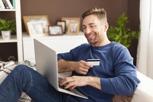 smiling-man-online-shopping-home
