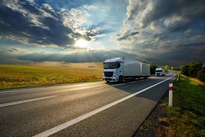 two-white-trucks-on-the-road