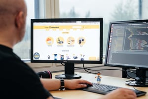 Person looking e-commerce web page and coding page simultaneously
